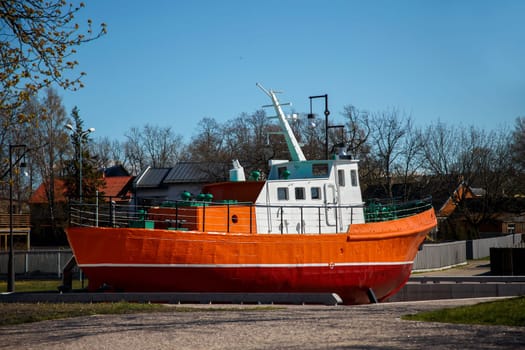 Small old fishing boat ashore set as a symbol, Ventspils, Latvia
