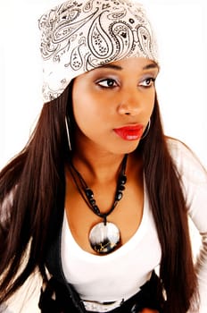 Lovely young woman in a portrait image with a head scarf, long brunette.hair and nice jewellery, isolated for white background.