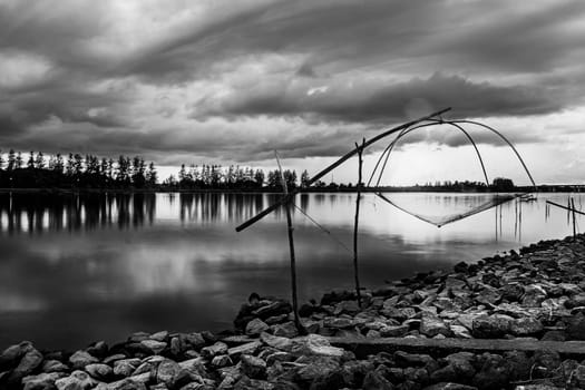 Sea sunset or sunrise with fishing tool countryside and colorful of sky and cloud with sunlight in twilight, Black and white and monochrome style