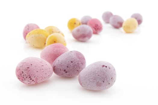 A group of small Easter eggs on white with selective focus and shallow depth of field