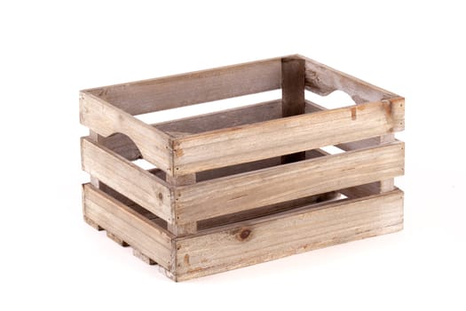 Small wooden box crate used for fruit or vegetables on a farm or shop. Slatted pine crate isolated on a white background