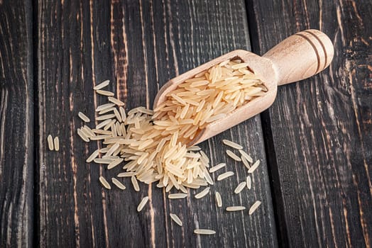 Long rice in scoop on dark table