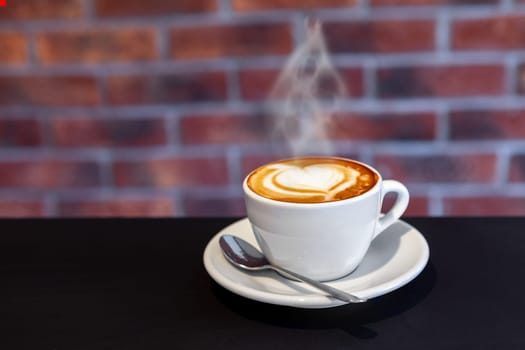 A cup of coffee on a with heart, valentines day, red wall, restaurant photo