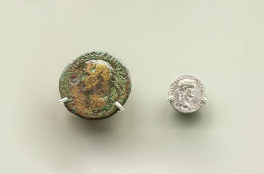 Merida, Spain - August 25th, 2018: Caligula Roman Emperor two coins, 37 AC, National Museum of Roman Art in Merida, Spain. Selective focus