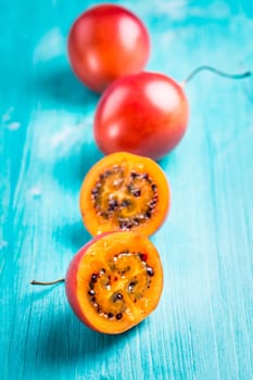 Fresh tamarillo fruit on wooden background