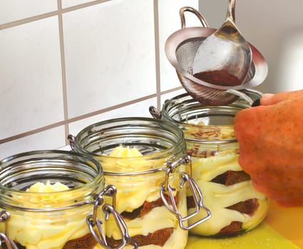 Glasses with Italian dessert on the worktop.