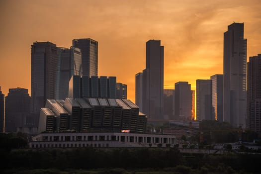Chongqing, China -  August 2019 : View of the tall highrise residential and commercial buildings in the  Chongqing city at dusk