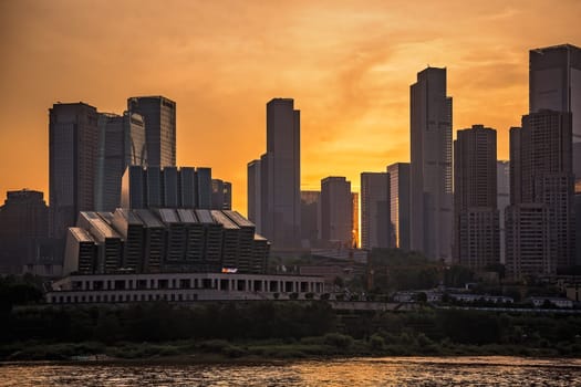Chongqing, China -  August 2019 : View of the tall highrise residential and commercial buildings in the  Chongqing city at dusk