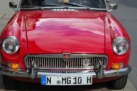 HEILIGENHAUS, NRW, GERMANY - SEPTEMBER 10, 2017:.Heiligenhaus, Nrw, Germany - September 10, 2017:.Oldtimer Morris Garages Model MGB front view in  red color, parked in Heiligenhaus, Deutschland.