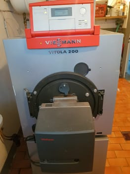 HEILIGENHAUS, NRW, GERMANY - FEBRUARY 15, 2019:.Heiligenhaus, Nrw, Germany - February 15, 2019:.A domestic boiler room with a new modern oil fuel boiler, and a hot water supply and piping.