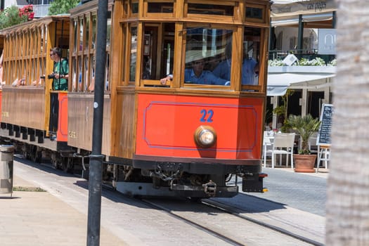 PORT DE SOLLER, SPAIN - JUNE 02, 2016:..Port De Soller, Spain - June 02, 2016:.Vintage train, tram on the beach promenade of the town of Soller in Spain. Opened in 1913, the driving distance is about 5 km long.