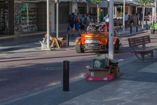 Paguera, MALLORCA, SPAIN - MAY 31, 2016:.Paguera, Mallorca, Spain - May 31, 2016: .. A couple is driving with a rental trike over the shopping street at Paguera Bay.