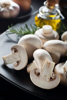 Mushrooms with ingredients on a black background