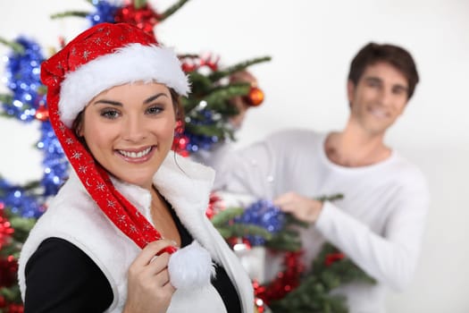 Couple decorating a Christmas tree