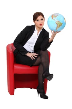 A woman holding a globe.