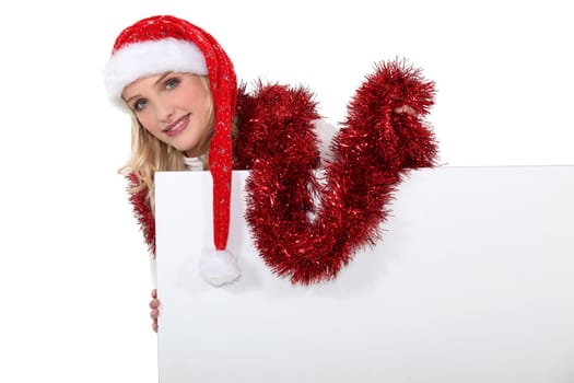 Festive woman stood with blank poster
