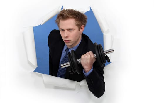 A businessman lifting a dumbbell