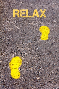 Yellow footsteps on sidewalk towards Relax message, Leisure conceptual image