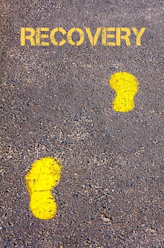 Yellow footsteps on sidewalk towards Recovery message, Healthy Living conceptual image