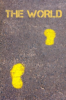 Yellow footsteps on sidewalk towards The World message, Globalisation conceptual image