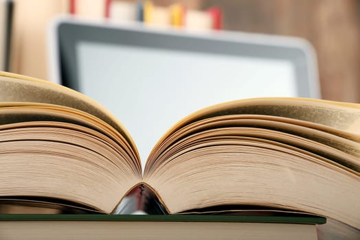 Composition with books and tablet computer on the table.