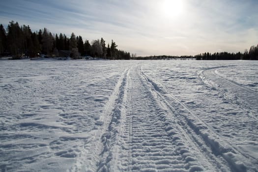 Snowmobile Tracks on Frozen Lake