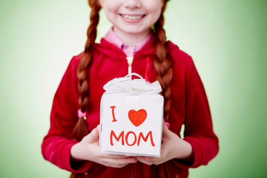 Close-up of a gift box in hands of little girl