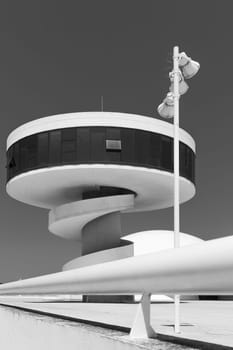 Aviles, Spain, May 19, 2018: Sight-seeing tower with external spiral staircase in the Oscar Niemeyer International Cultural Centre, with a balustrade in the foreground