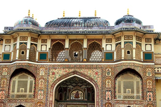 Highly decorative front, top portion of Ganesh Pole at Amer Palace in Jaipur, Rajasthan, India, Asia