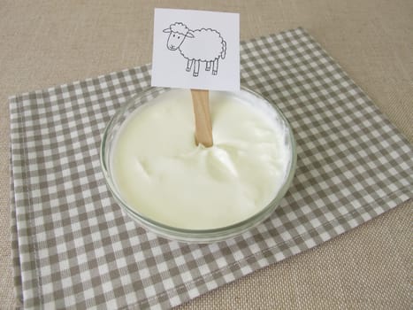 Fresh sheep quark, farmer cheese from the sheep in a glass bowl