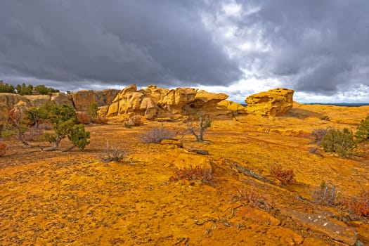 Sun Breaking Through the Clouds on a Colorful Sandstone Ridge in El Malpais National Monument in New Mexico