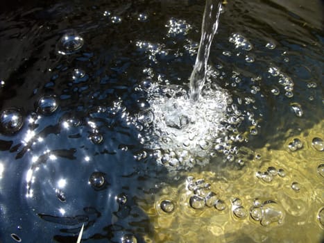 Waterstream with sun reflections