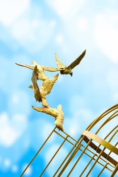 gold Sculpture of a Dove Being Set Free