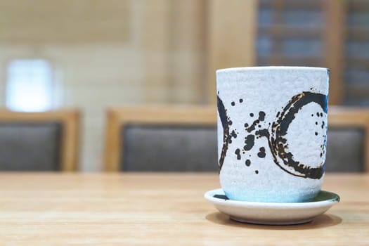 Japanese hot tea cup at restaurant with copy space
