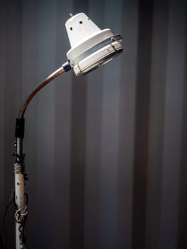 the old white desk lamp on black background