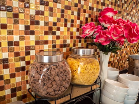 Fruit juice dispensers and coffee & tea water on a self service breakfast counter in a hotel.
