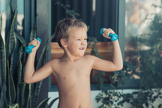 Portrait of a boy doing exercises. Self isolation at home