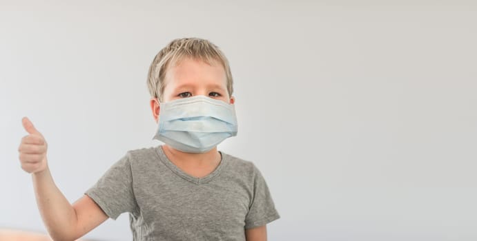 Boy wearing facial disposable mask to avoid viral infection. Stop coronavirus
