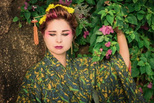 Fine art portrait of beautiful woman in Japanese Geisha style wearing kimono