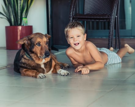 Portrait of a boy with dog. Self isolation at home