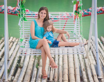Outdoor portrait of a beautiful happy family. Mother and daughter together
