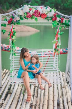 Outdoor portrait of a beautiful happy family. Mother and daughter together