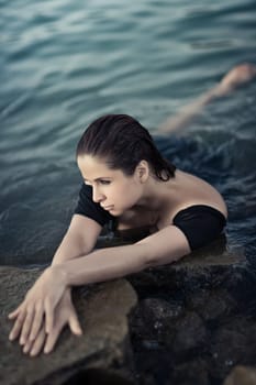 Portrait of a beautiful sexy woman outdoor. Model near the sea