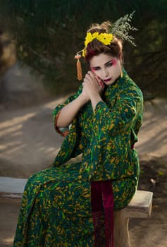 Fine art portrait of beautiful woman in Japanese Geisha style wearing kimono