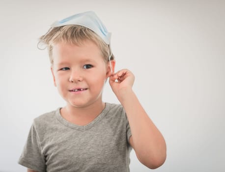 Boy wearing facial disposable mask to avoid viral infection. Stop coronavirus