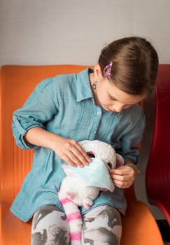 Girl wearing facial disposable mask to avoid viral infection. Virus protection