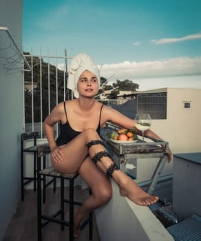 Fashion style portrait of a beautiful woman on a balcony