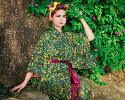 Fine art portrait of beautiful woman in Japanese Geisha style wearing kimono