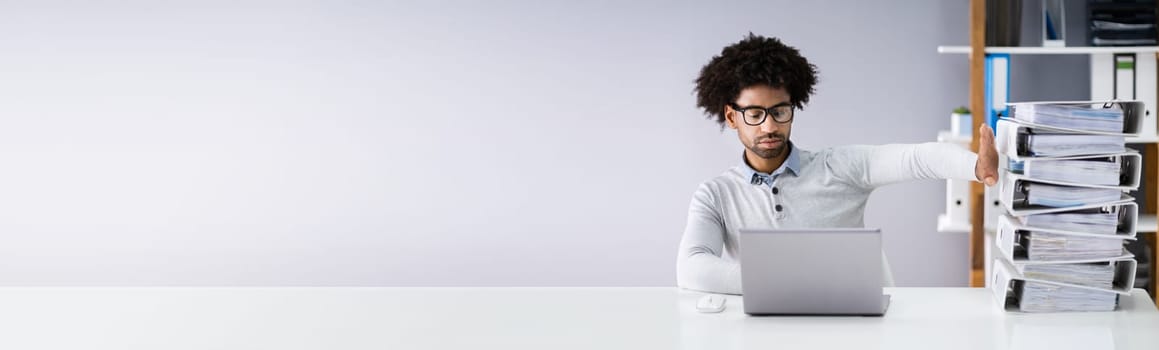 Businessperson Pushing Paper Documents Away And Working With Digital Documents On Computer Instead