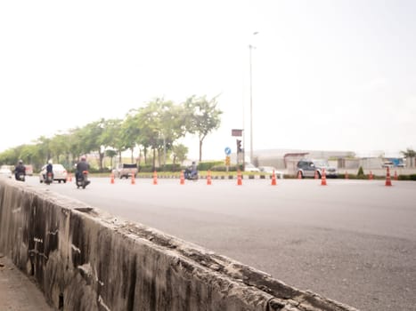 Highway traffic in sunset. Road with metal safety barrier or rail.